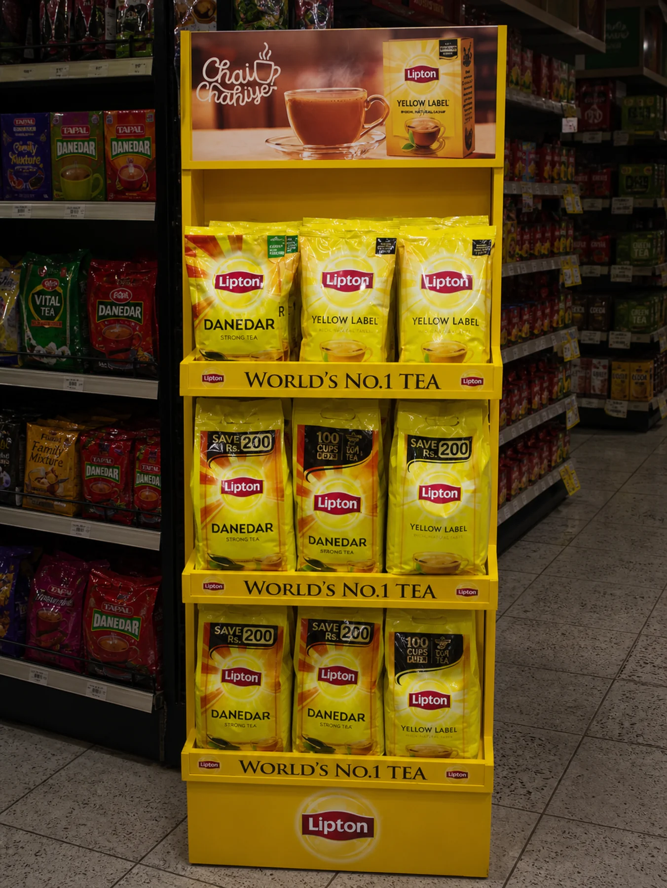 Stocked yellow Lipton gondola end in a Karachi supermarket