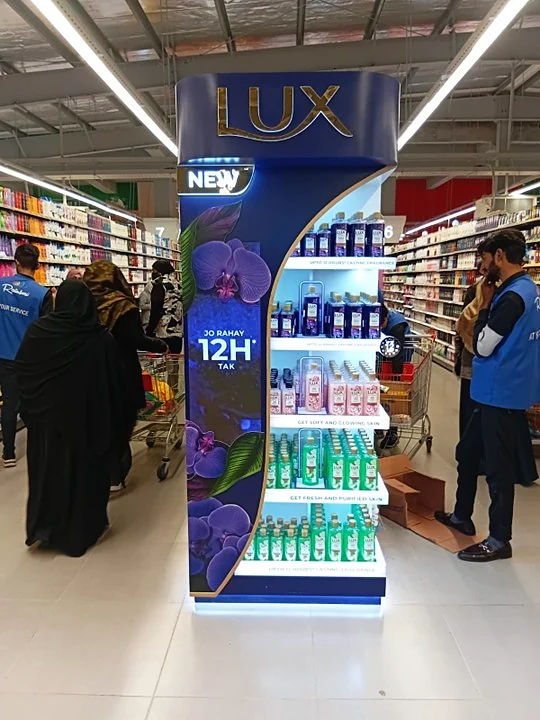 Illuminated Lux Bodywash freestanding unit with its curved lit profile